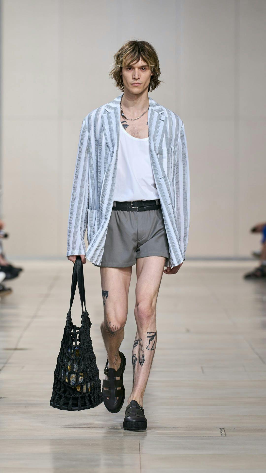 clothing shorts fashion person skin tattoo bag handbag coat sandal